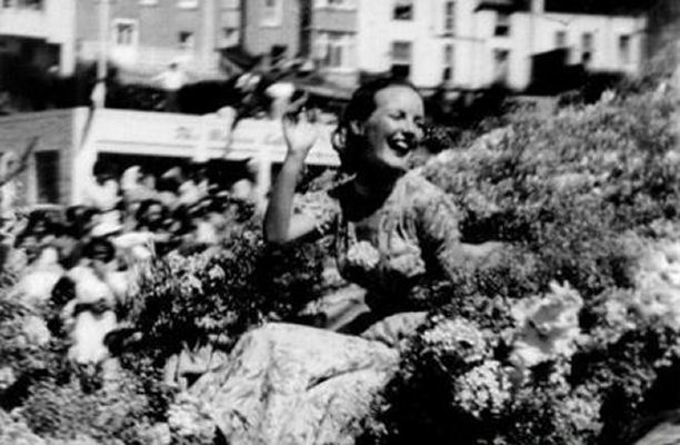 Petula driving through the arena atop a decorated float